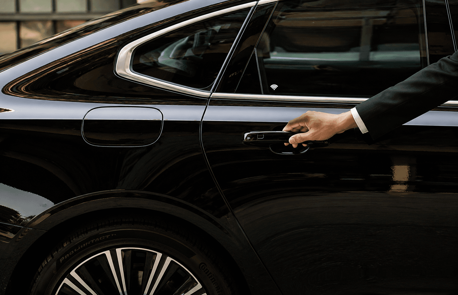 Chauffeur assisting guests at an airport transfer pickup