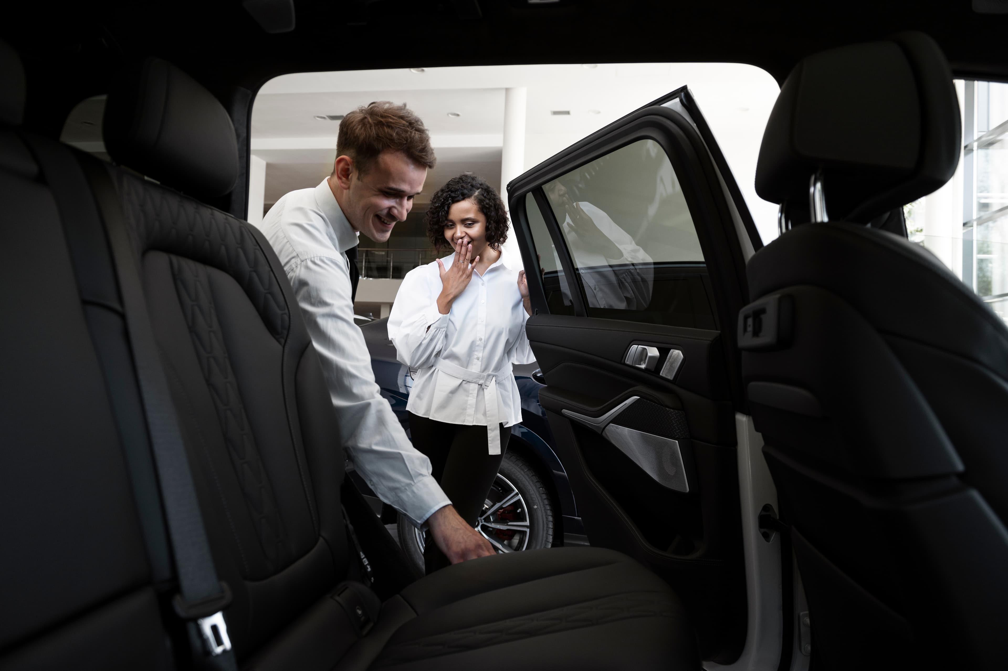 Chauffeur assisting guests at an airport transfer pickup